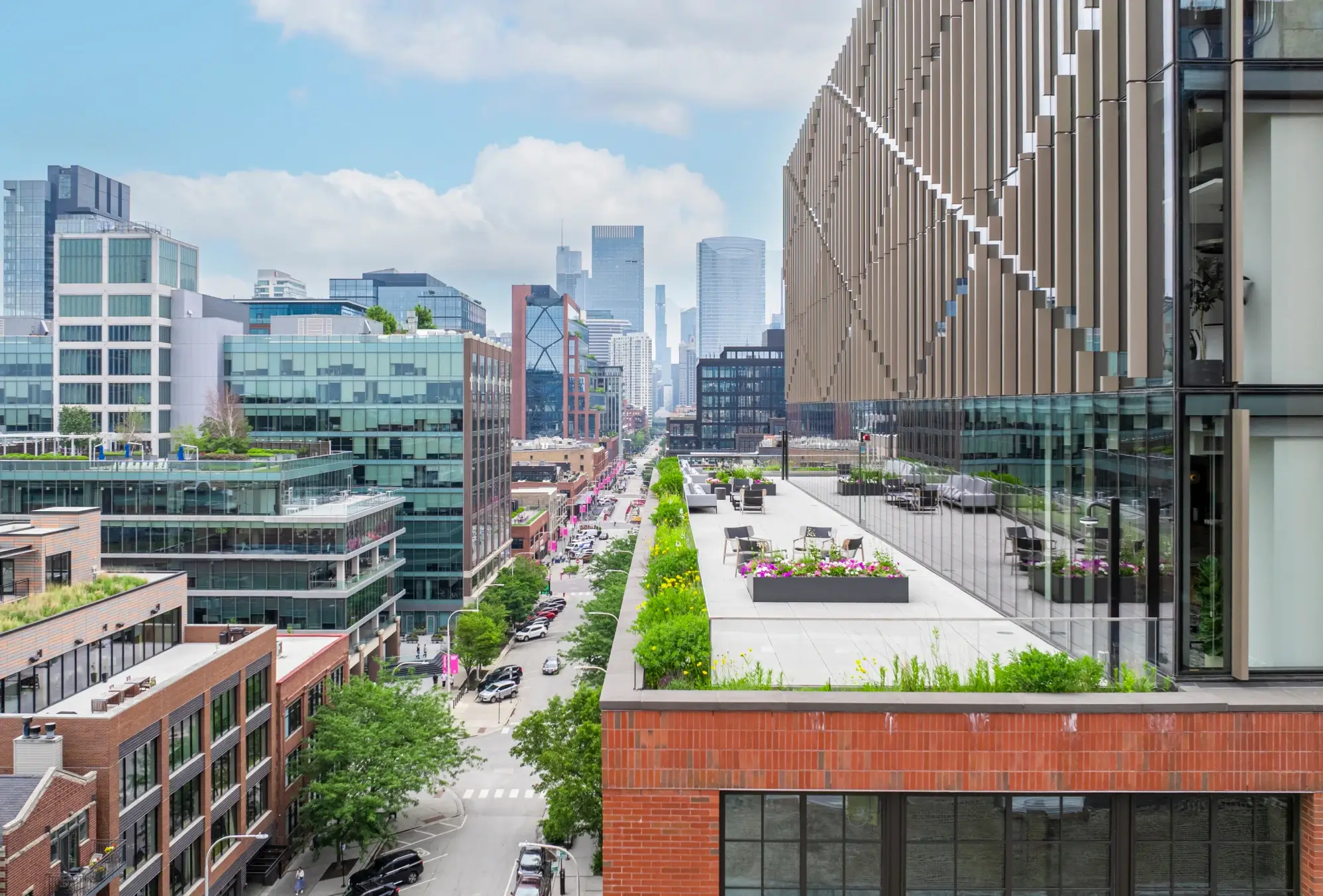 Panoramic city view from rooftop garden terrace overlooking street and skyline in Chicago