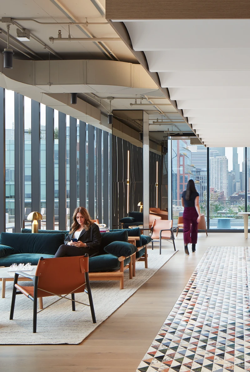 Lounge area with stylish lounge chairs, ceiling treatments, and floor-to-ceiling glass windows.